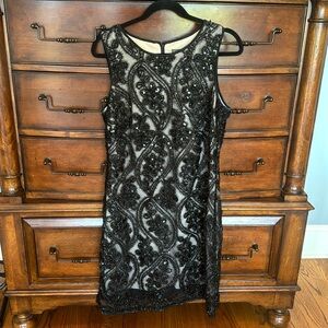 Beautiful and classy black cocktail dress. Taylor size 12.
